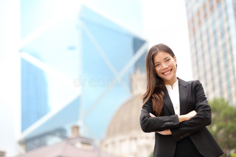 Young Asian business people business woman portrait outside. Businesswoman standing proud looking at camera in suit. Multiracial Chinese Asian / Caucasian female professional in central Hong Kong. Young Asian business people business woman portrait outside. Businesswoman standing proud looking at camera in suit. Multiracial Chinese Asian / Caucasian female professional in central Hong Kong.