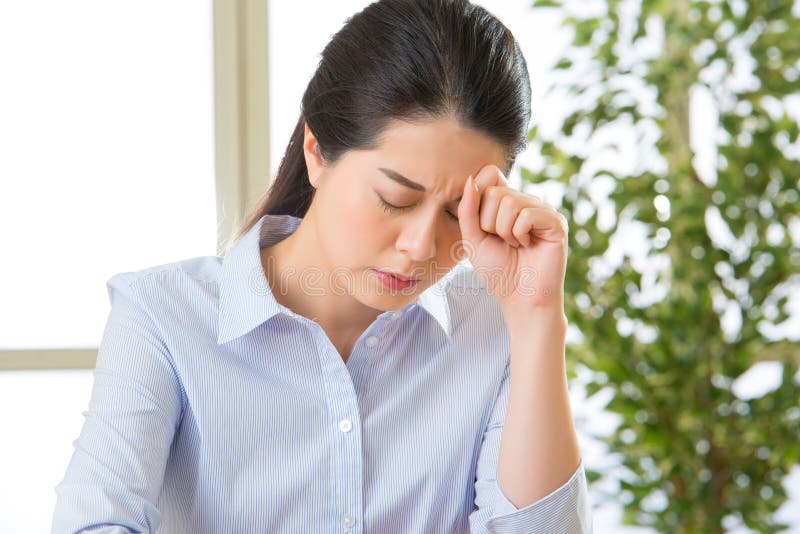 Young asian business woman with headache royalty free stock image Young asian business woman with headache royalty free stock image
