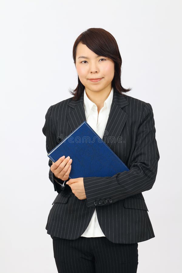 Young asian business woman holding a book