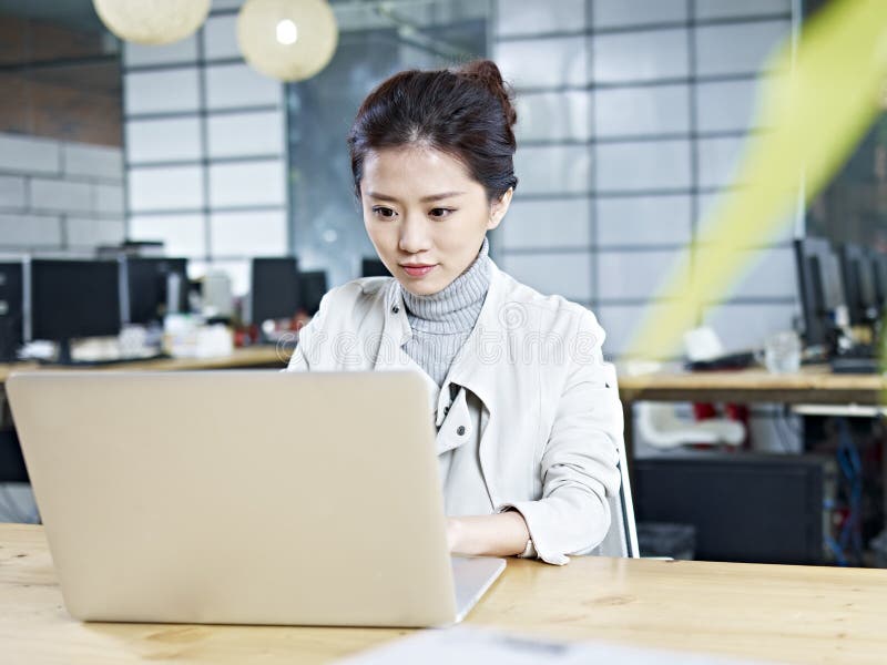 Young asian business woman working in office royalty free stock photography