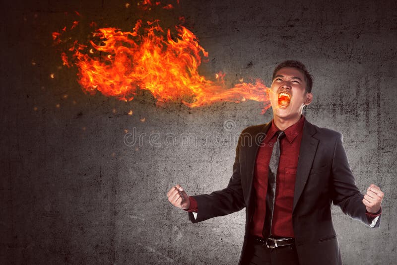 Young asian businessman in anger burning in flame