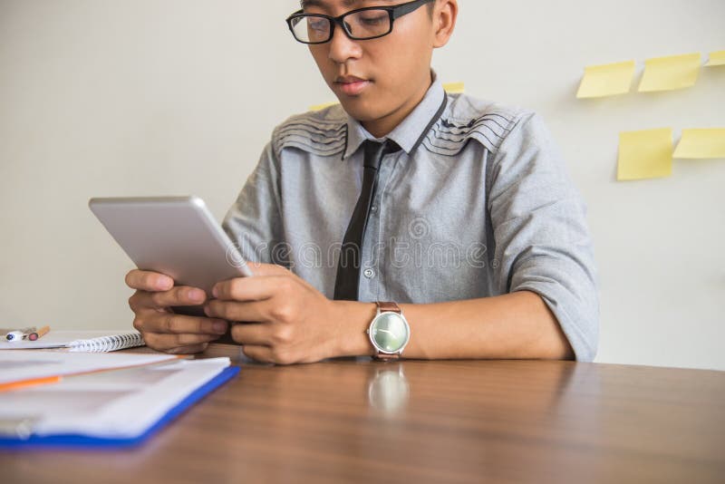 Young businessman using tablet in the office royalty free stock photo Young businessman using tablet in the office royalty free stock photo
