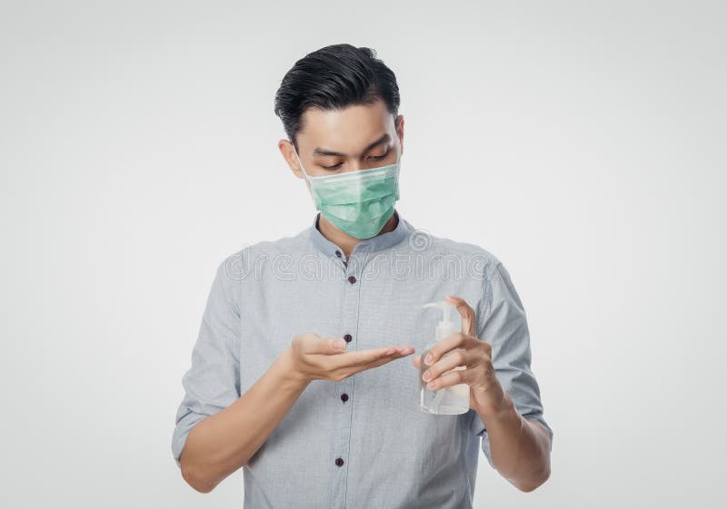 Young Asian Businessman wearing hygienic mask and using hand sinitizer or alcohol gel, Prevent infection, 2019-nCoV or coronavirus