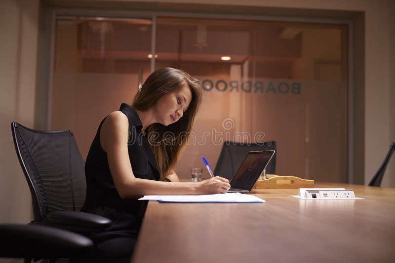 Young Asian businesswoman working alone late in an office