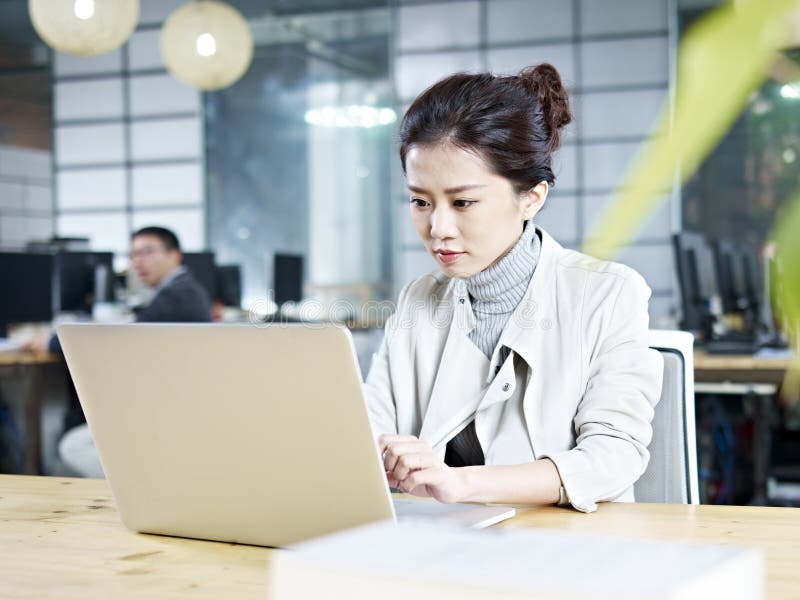 Young asian businesswoman working in office stock image Young asian businesswoman working in office stock image
