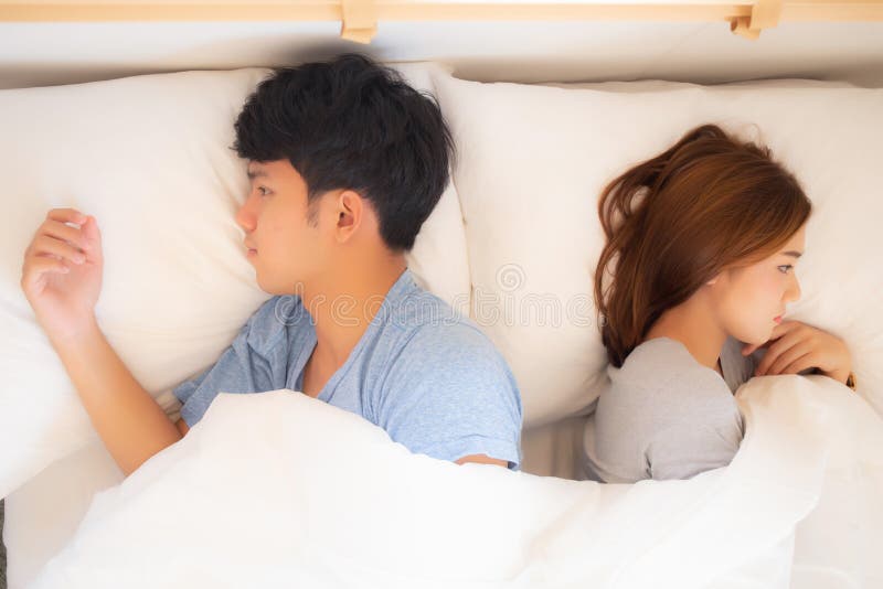 Young asian couple lying separate and failure on bed at home, asia family having problem conflict and divorce royalty free stock photos Young asian couple lying separate and failure on bed at home, asia family having problem conflict and divorce royalty free stock photos
