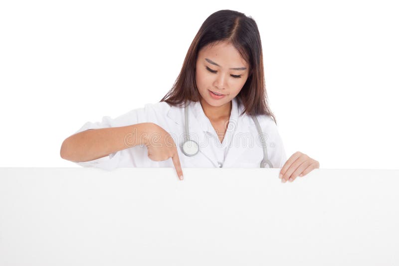 Young Asian female doctor point and look down to blank sign isolated on white background