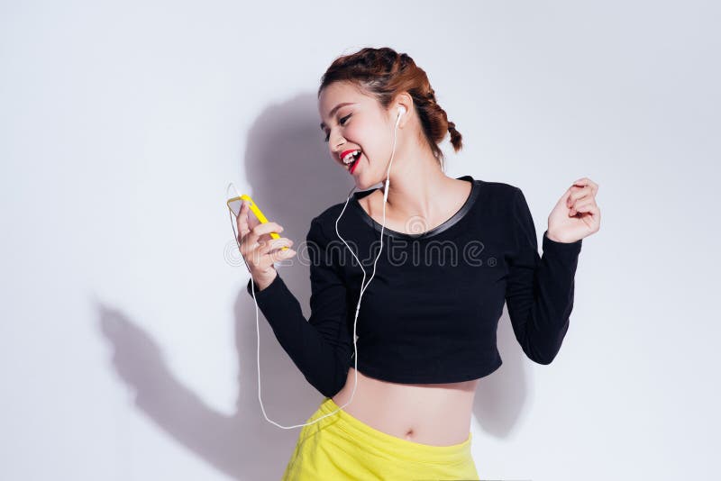 Fashion lifestyle portrait of young happy pretty woman listening favorite music,stylish vintage outfit. white background