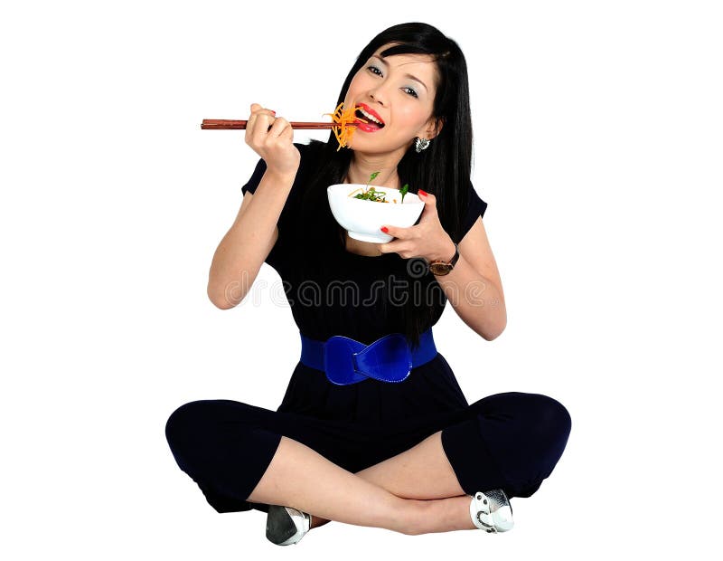 Young asian girl eating salad