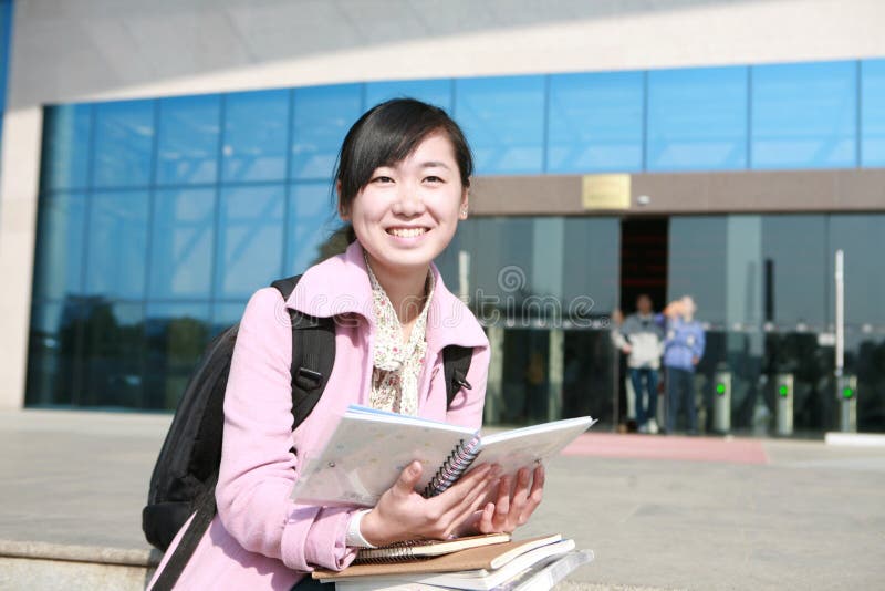 Young asian girl holding books