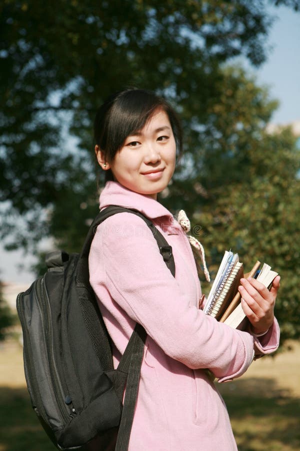 Young asian girl holding books