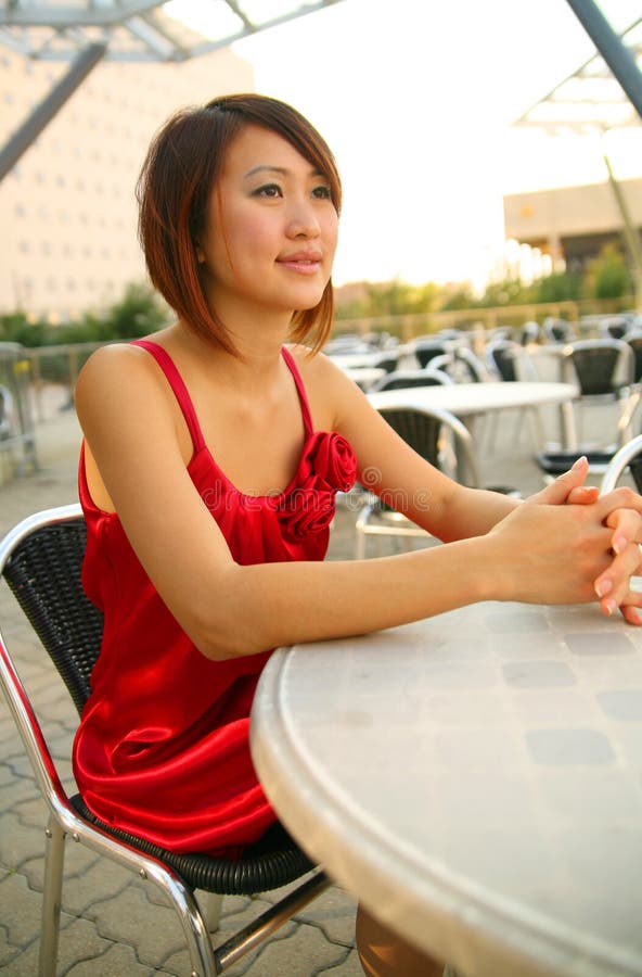 Young Asian Girl Waiting On Outdoor Cafe