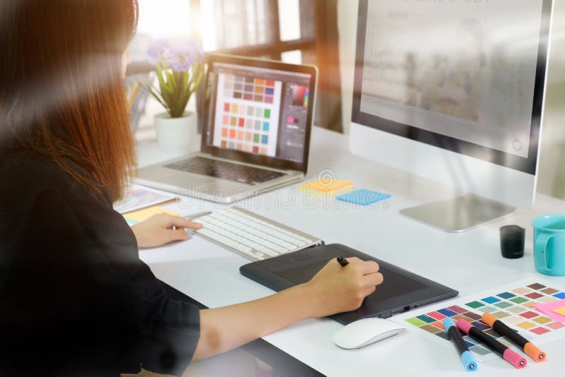 Young asian graphic designer working on computer stock photo