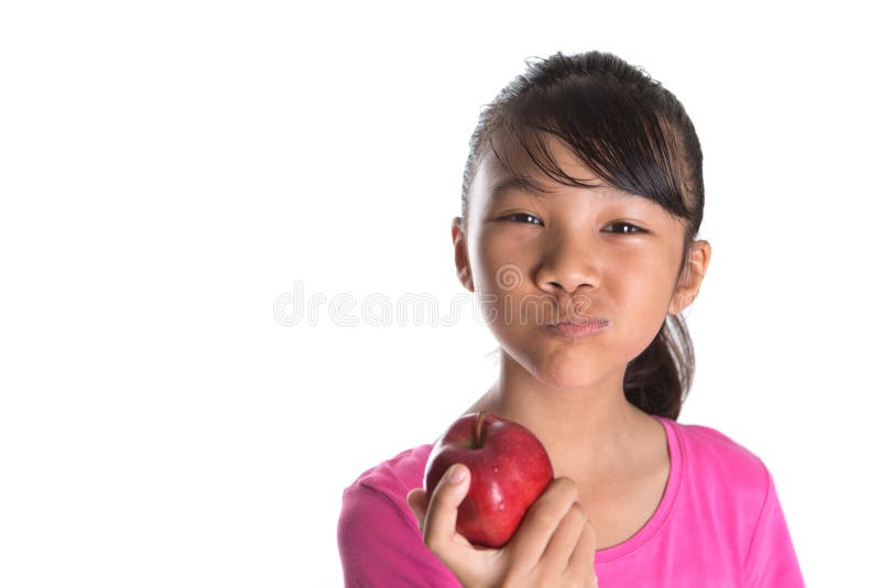 Young Asian Malay Teenager Eating Red Apple IX