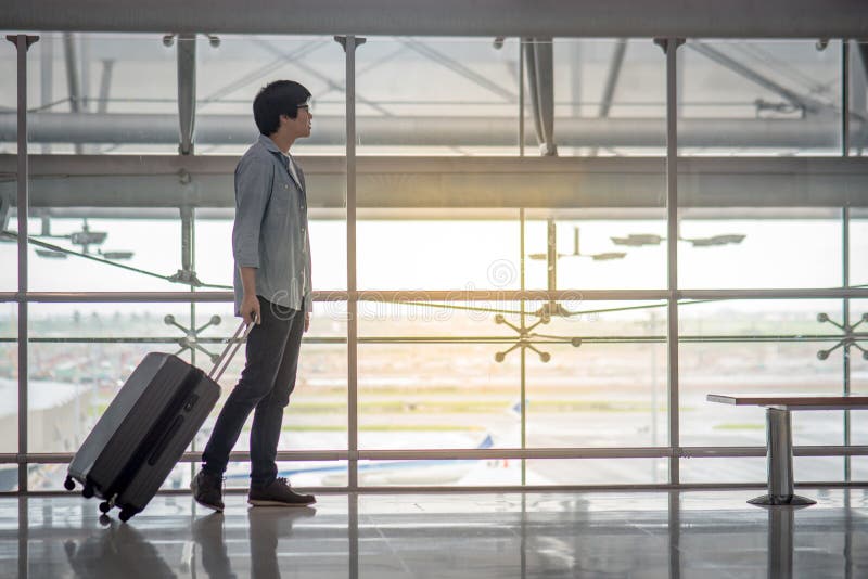 Young Asian Man with Luggage in Airport Terminal Stock Image - Image of ...