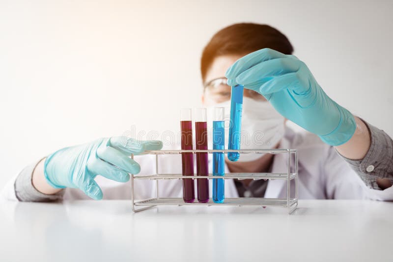 Young asian man medical researcher looking test tubes glass in l royalty free stock photography Young asian man medical researcher looking test tubes glass in l royalty free stock photography
