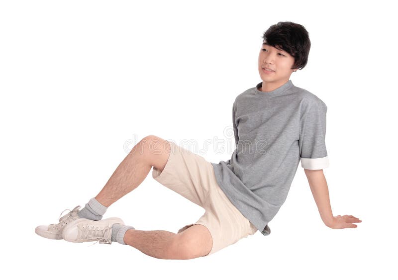 Young Asian man sitting on floor.