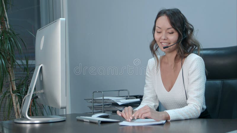 Young asian operator talking with customer in international call center royalty free stock photo