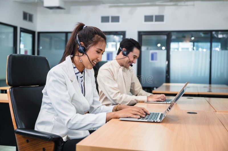 Young asian operator woman agent with headsets working customer service in a call center stock photography