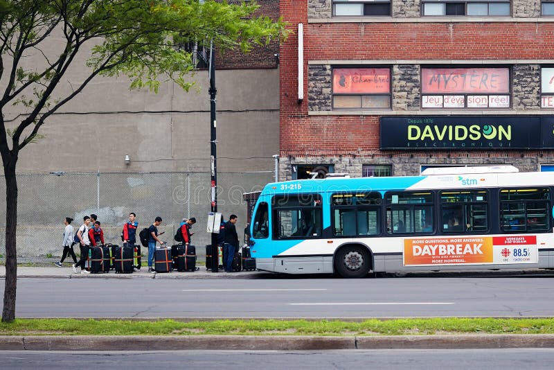Young Asian people waiting in queue with their lugagges to get on the bus in Montreal, Quebec, canada royalty free stock photography Young Asian people waiting in queue with their lugagges to get on the bus in Montreal, Quebec, canada royalty free stock photography
