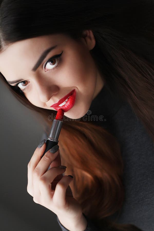 Young asian woman with dark hair using red lipstick royalty free stock photos Young asian woman with dark hair using red lipstick royalty free stock photos