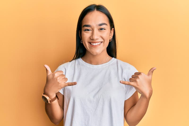 Young asian woman doing shaka sign with hands smiling with a happy and cool smile on face stock images
