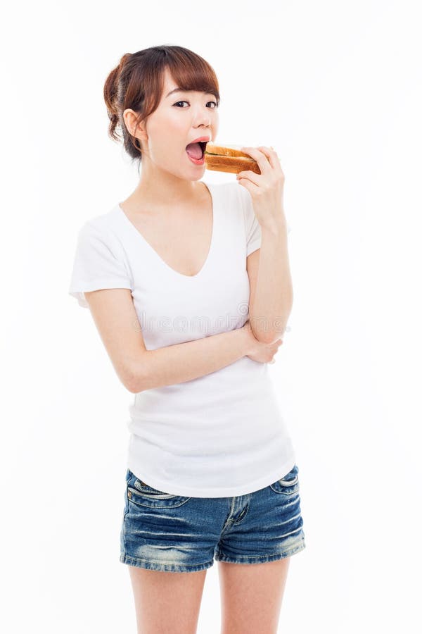 Young Asian woman eat sandwhich ioslated on white. Young Asian woman eat sandwhich ioslated on white.