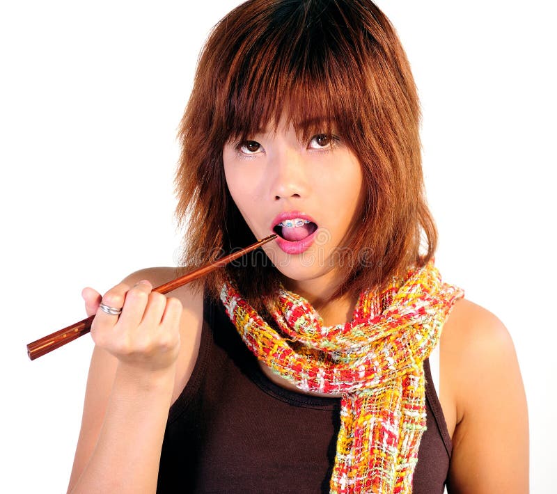 Young asian woman eating sushi