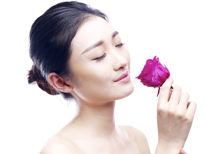 Young asian woman enjoying fragrance of red rose royalty free stock image Young asian woman enjoying fragrance of red rose royalty free stock image
