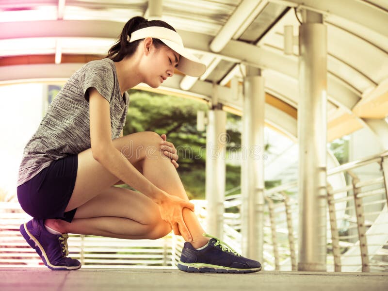 Young asian woman has legs pain, after exercise training. Lifestyle and healthy concept. royalty free stock images Young asian woman has legs pain, after exercise training. Lifestyle and healthy concept. royalty free stock images
