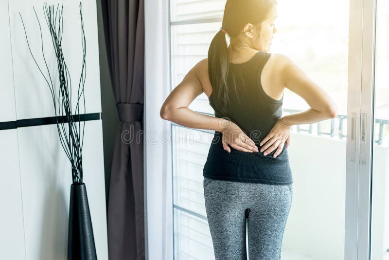 Young woman suffering from flank pain on white background Stock Photo