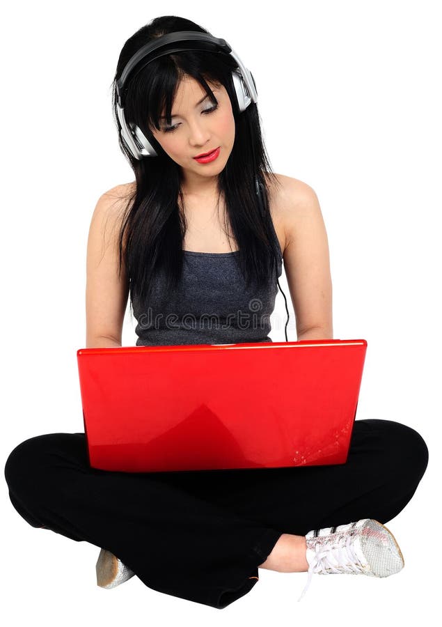 Young asian woman listening music from the compute