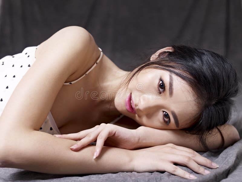 Young asian woman lying on floor royalty free stock images Young asian woman lying on floor royalty free stock images