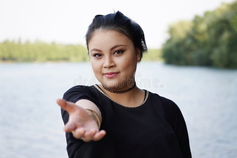 Young asian woman reaching out