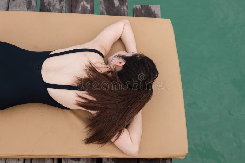 Young asian woman is sunbathing on the beach stock photography Young asian woman is sunbathing on the beach stock photography