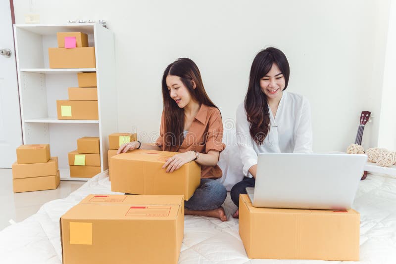 Young Asian woman startup small business entrepreneur SME distribution warehouse with parcel mail box. Owner home office concept. stock photos Young Asian woman startup small business entrepreneur SME distribution warehouse with parcel mail box. Owner home office concept. stock photos