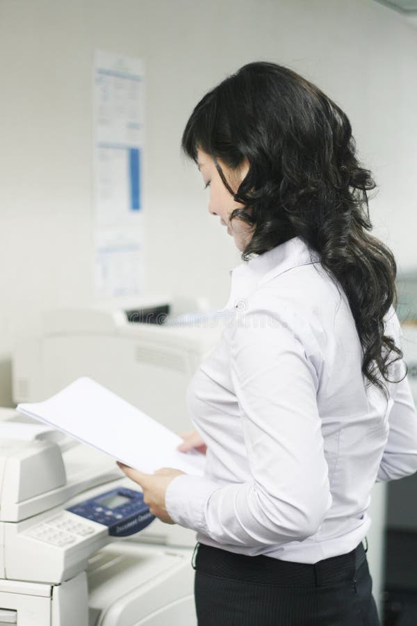 Young asian working with print