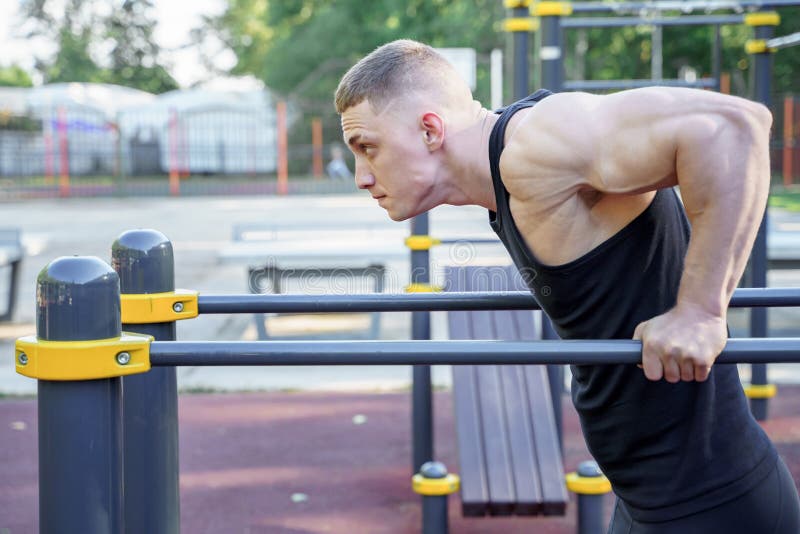 Young Athletic Man Doing Pushups on Bars Outdoors Stock Image Image