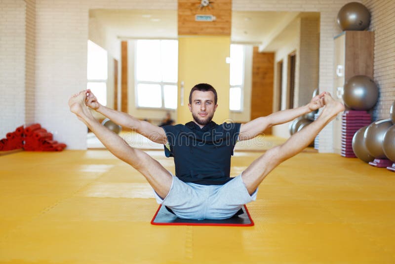 Young male trainer doing yoga exercise in gym royalty free stock photos Young male trainer doing yoga exercise in gym royalty free stock photos