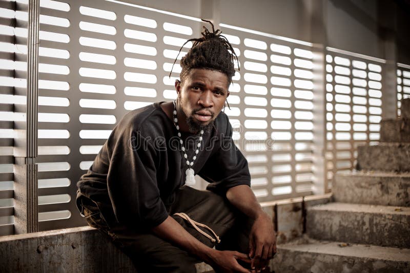 Young and attractive afro american man sitting near the window royalty free stock photography Young and attractive afro american man sitting near the window royalty free stock photography