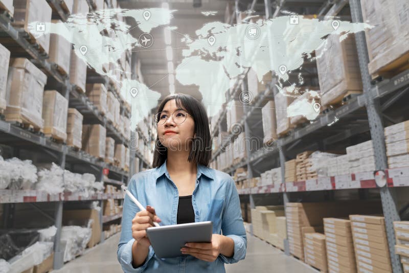 Young attractive asian manager woman looking, picking, replemishment, receiving inventory at store warehouse in warehouse royalty free stock photos Young attractive asian manager woman looking, picking, replemishment, receiving inventory at store warehouse in warehouse royalty free stock photos