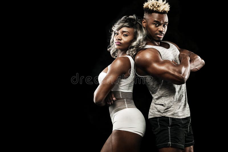 Fitness couple of athletes posing on black background, healthy lifestyle body care. Sport concept with copy space. royalty free stock images Fitness couple of athletes posing on black background, healthy lifestyle body care. Sport concept with copy space. royalty free stock images