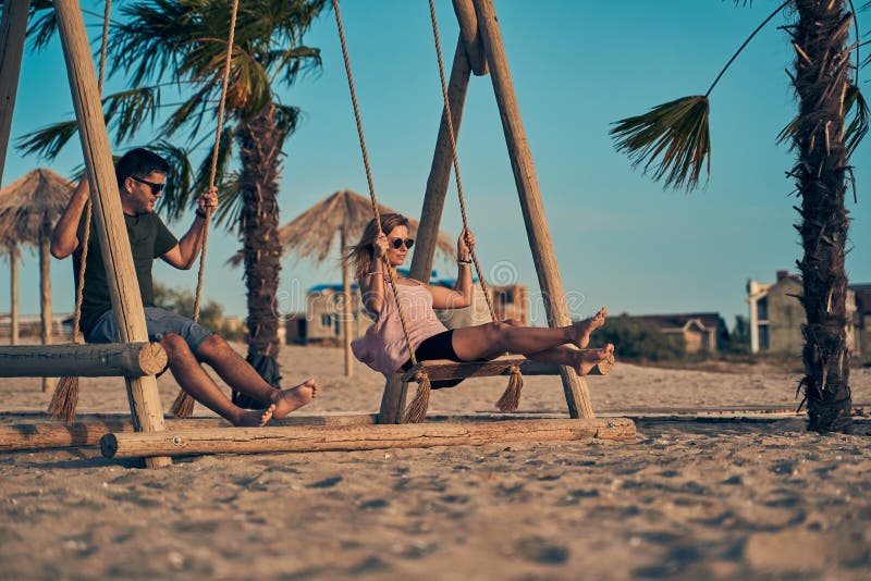 270 Couple Swinging Beach Beach Stock Photos photo