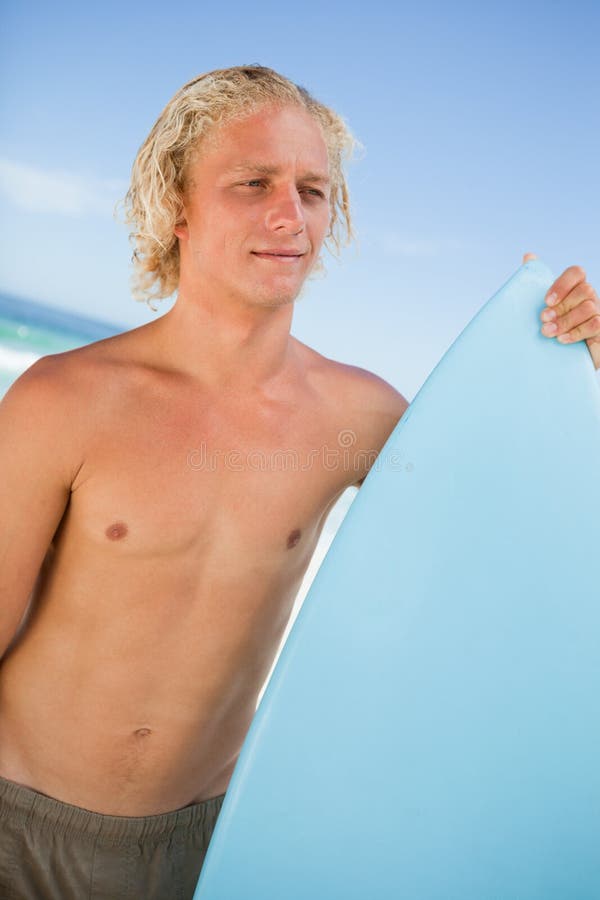 Young Attractive Man Holding His Perched Surfboard in Front of T Stock ...
