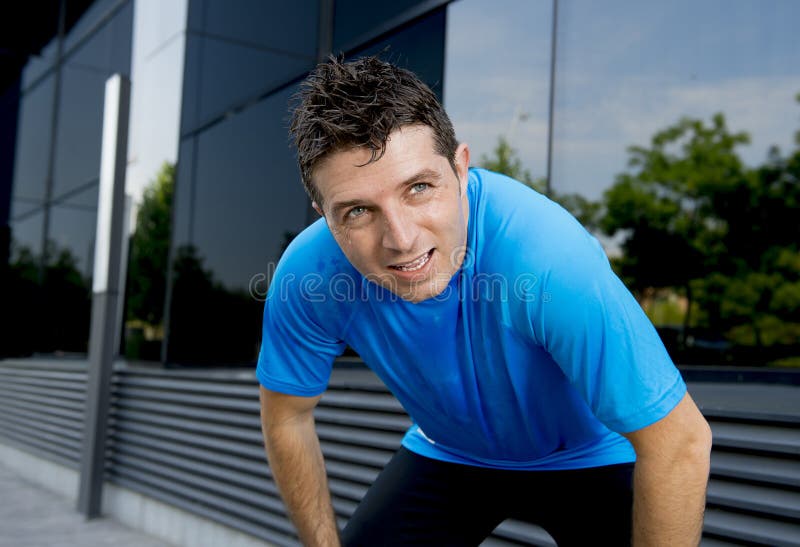 Young attractive man leaning exhausted after running session sweating taking a break to recover in urban street royalty free stock photo Young attractive man leaning exhausted after running session sweating taking a break to recover in urban street royalty free stock photo