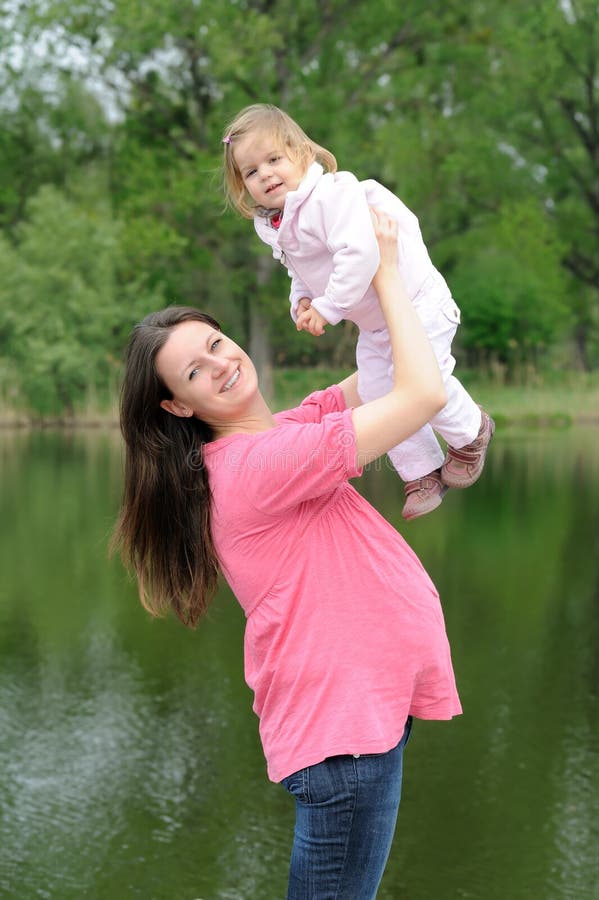 Young attractive pregnant woman with her baby