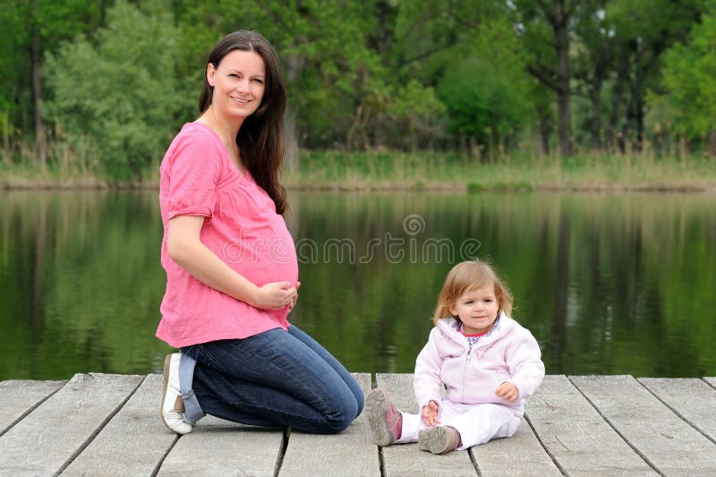 Young attractive pregnant woman with her toddler