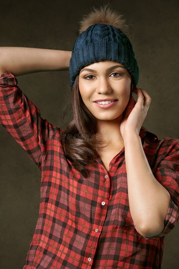 Young, attractive, smiling woman adjusting a winter hat stock photos Young, attractive, smiling woman adjusting a winter hat stock photos