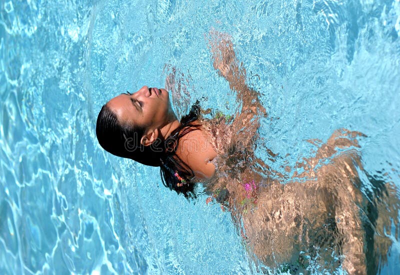 Young, attractive Spanish woman swimming in pool stock images Young, attractive Spanish woman swimming in pool stock images