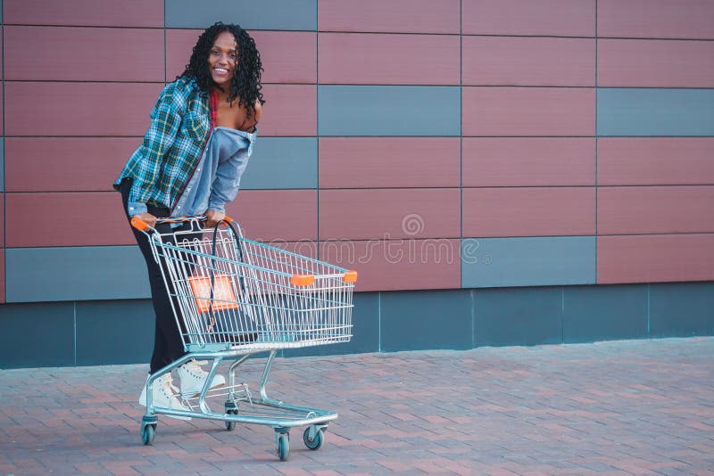 Young Beautiful Woman Dressed in Casual Clothes with a Shopping Cart ...